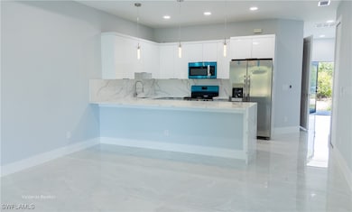 Kitchen featuring tasteful backsplash, a peninsula