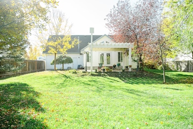 Rear view of house with a fenced backyard, a pergola, french doors, and a patio