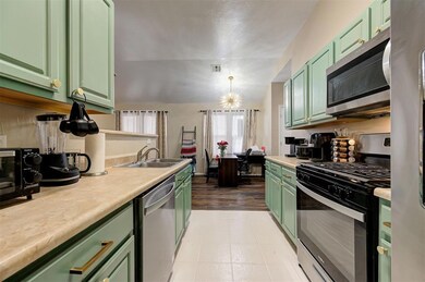 Kitchen with a sink, visible vents, appliances wit