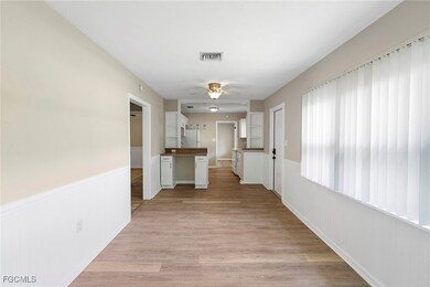 Hall with wainscoting and light wood-type flooring
