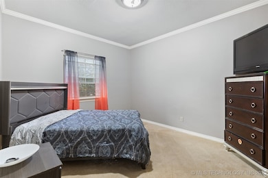 Bedroom featuring crown molding, light colored car