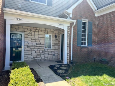 Property entrance with brick siding and stone siding