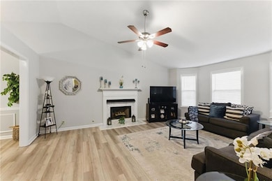 Living area with a high end fireplace, light wood-