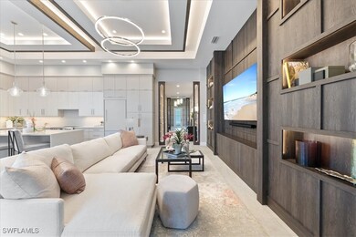 Living area with a tray ceiling, recessed lighting