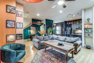 Living room featuring light wood-style floors, a ceiling fan, and recessed lighting