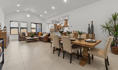 Dining area & great room with soaring vaulted ceiling