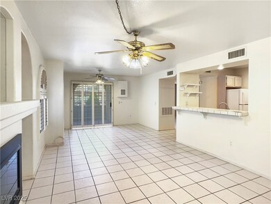 Unfurnished living room featuring light tile patte