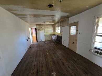 Kitchen with dark hardwood / wood-style flooring a