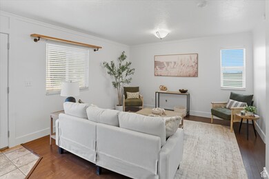 Living area featuring crown molding and wood finished floors