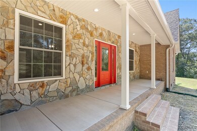 View of exterior entry featuring covered porch