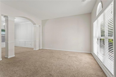Empty room featuring arched walkways, ornamental m