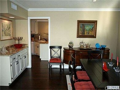 Dining area with bar with sink to the left and doo