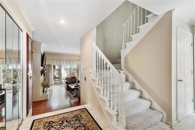 Foyer with staircase, toward living room.