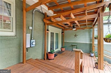 Wooden terrace featuring a ceiling fan
