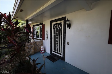 Property entrance with stucco siding and covered porch