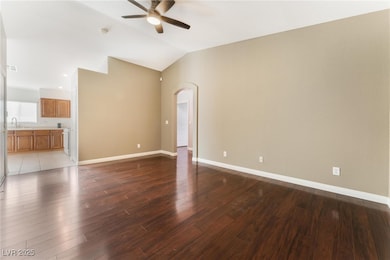 Unfurnished living room featuring a ceiling fan, a