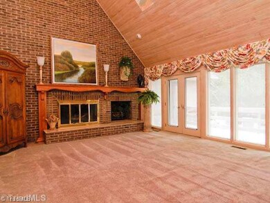 Living Room. Formal Living Room with a wall of windows that looks out onto inground pool.