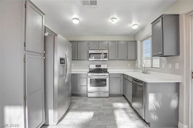 Sunny kitchen with garden window, stainless steel