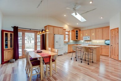 The kitchen offers a center island, maple cabinets