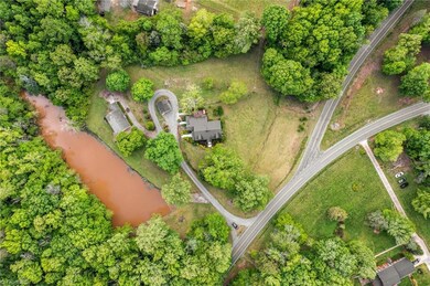 Overhead photo showing the main house and guest house with the pond.