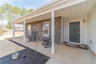 Property entrance with a porch and stone siding