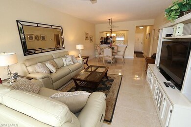 Living room with a notable chandelier and light ti