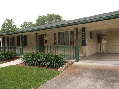 Front with porch, carport and gate to backyard