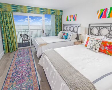Bedroom with a water view, access to exterior, and wood finished floors