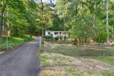 View of front of property featuring a forest view