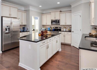 Enjoy spacious cabinetry and great work countertops along with stainless appliances and a  large walk-in corner pantry. Let the good times begin in comfort and convenience in here, and the fun will naturally overflow into the open concept family room.