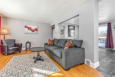 The cozy living room flows openly with the kitchen