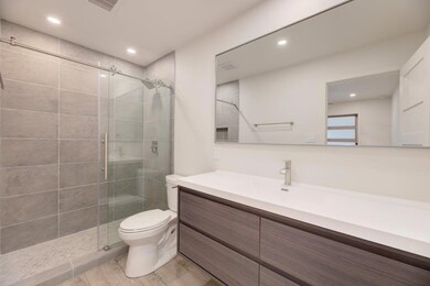 Full bath with toilet, a shower stall, visible ve