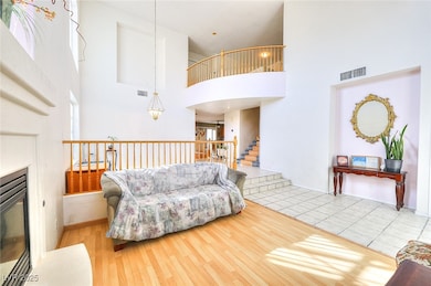 Living room with a high ceiling, wood finished flo
