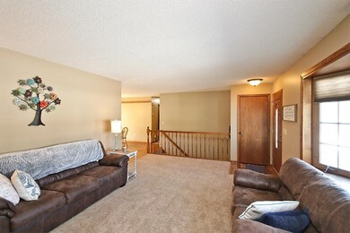 Living room and open staircase to lower level.