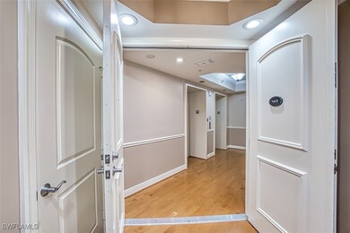 Hallway with hardwood / wood-style floors, a raise