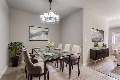 Dining room with light tile patterned floors and a chandelier