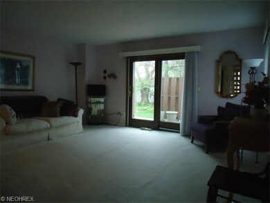 The living room has a nutral dcor and a freshly cl