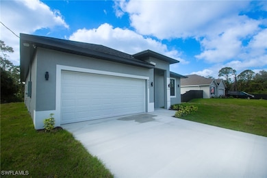 View of front of property with a garage, a front y