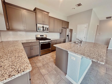 Kitchen with stainless steel appliances, a sink, 
