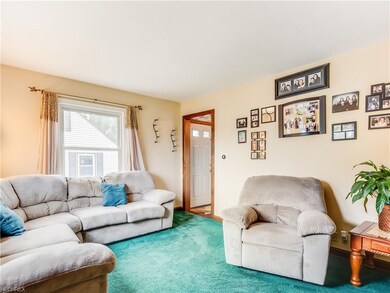Family room open through a wood arch to foyer