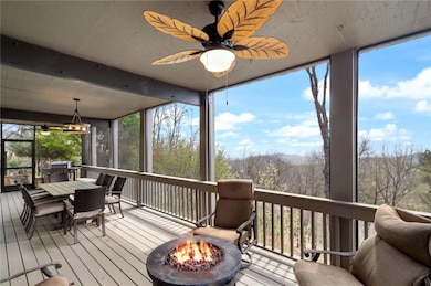 Sunroom with plenty of natural light, hardwood / wood-style flooring, beam ceiling, and a wooden deck