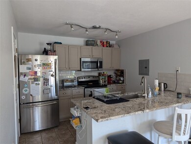 Kitchen featuring stainless steel appliances, a br
