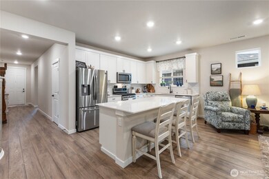 Open and bright with a walk in pantry the oversized island offers plenty of eating and cooking space.