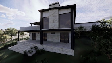 Rear view of house with stone siding and a patio