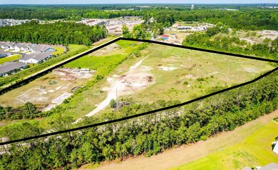 Aerial view of property and surrounding area with property parcel outlined