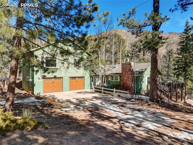 View of front of home with a garage and a mountain