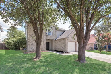 View of front facade with a garage and a front law