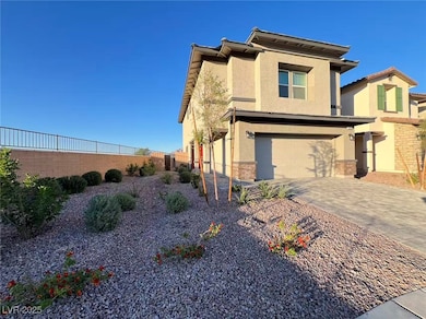 View of front of house featuring stucco siding, an attached garage, and decorative driveway