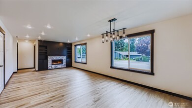 Great room with gas fireplace opens to dining area