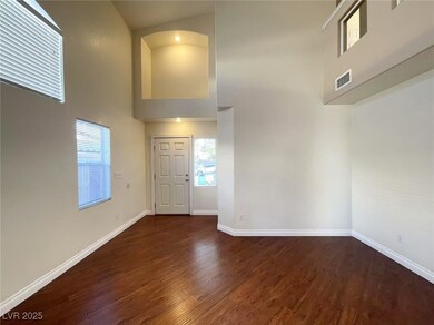 Foyer featuring a towering ceiling, dark wood-type